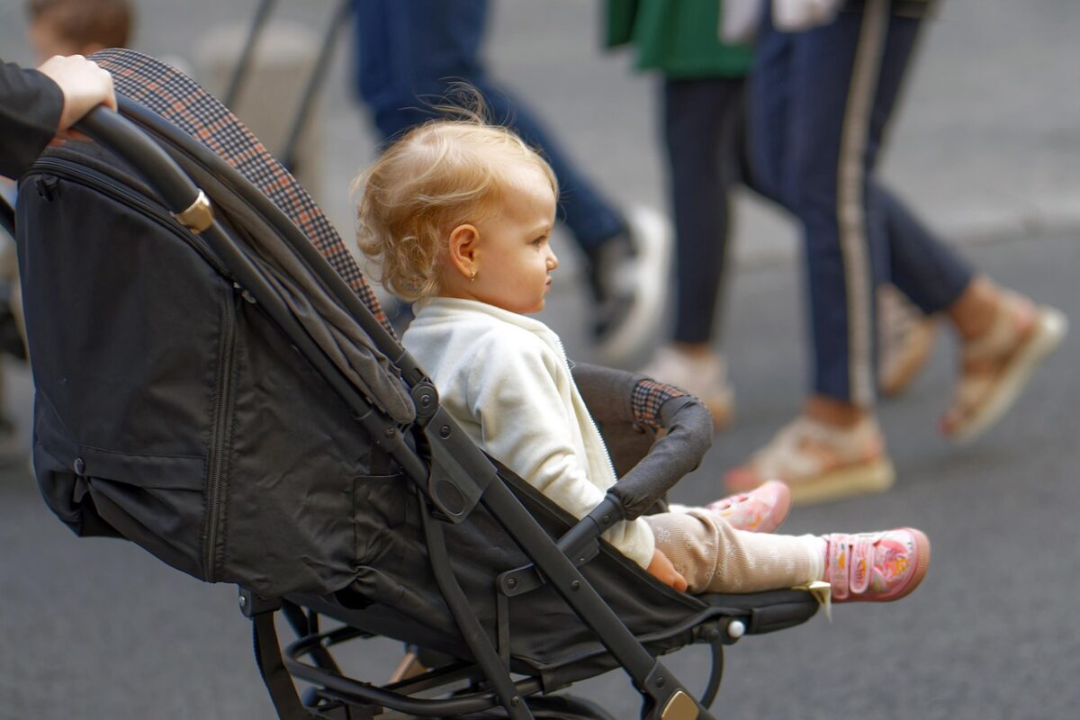 Infant car seat clicking into a stroller frame