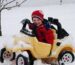 Child buckled into a car seat wearing a thin layer