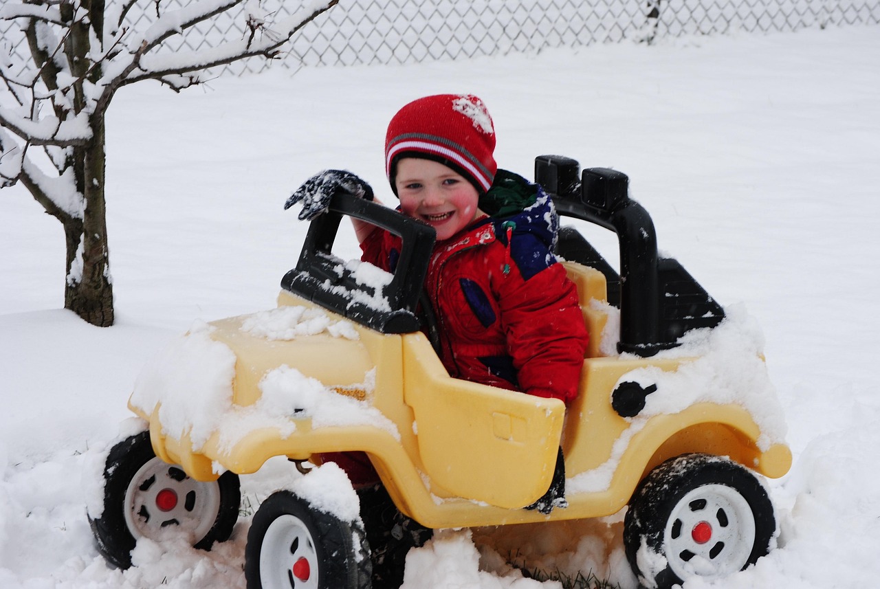 Child buckled into a car seat wearing a thin layer